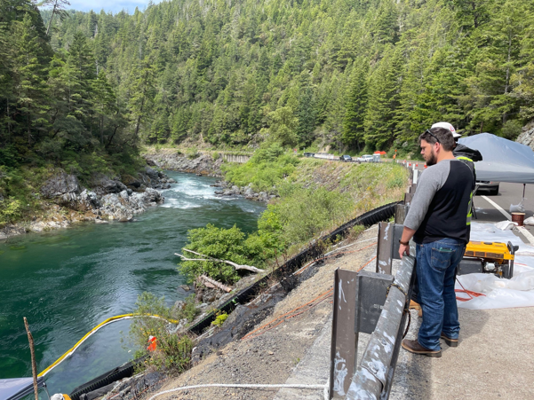 water spill with man looking at creek